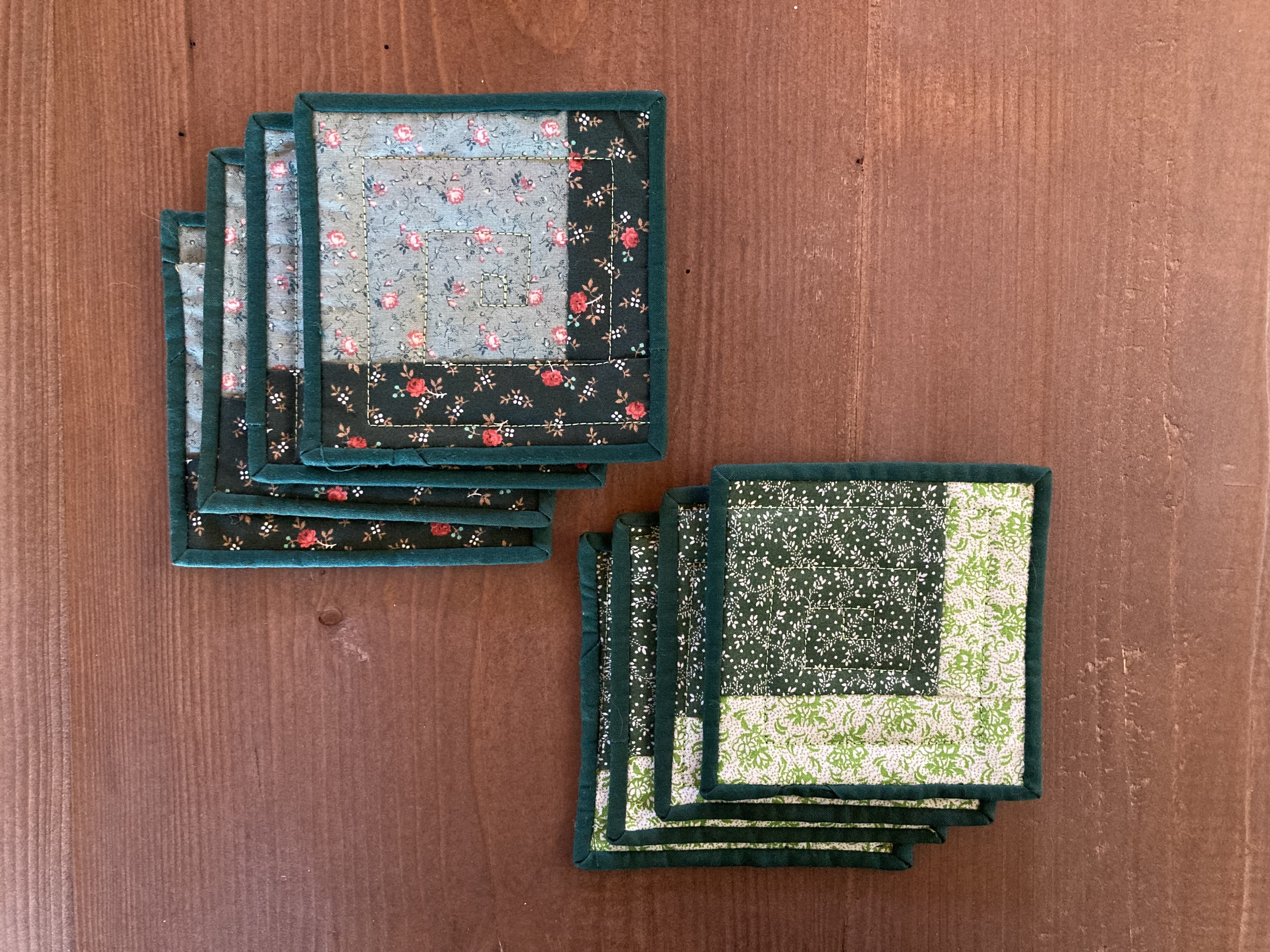 two stacks of quilted coasters in various green floral prints