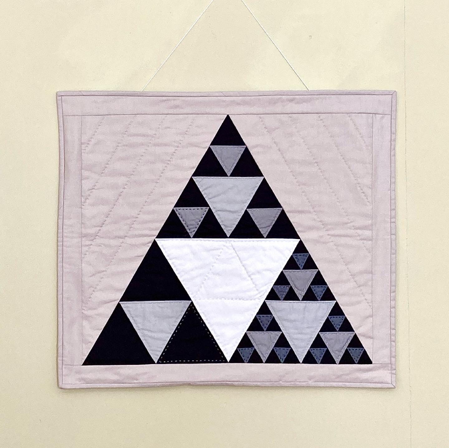 Sierpinski triangle fractal wall-hanging quilt in neutral colors